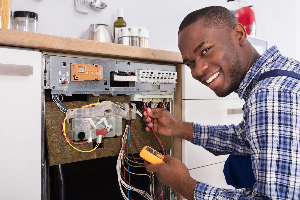 Electrician testing an electrical panel with a multimeter